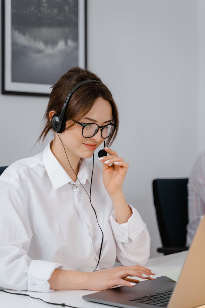 about-img-01 Professional woman using headset for customer service in office setting.