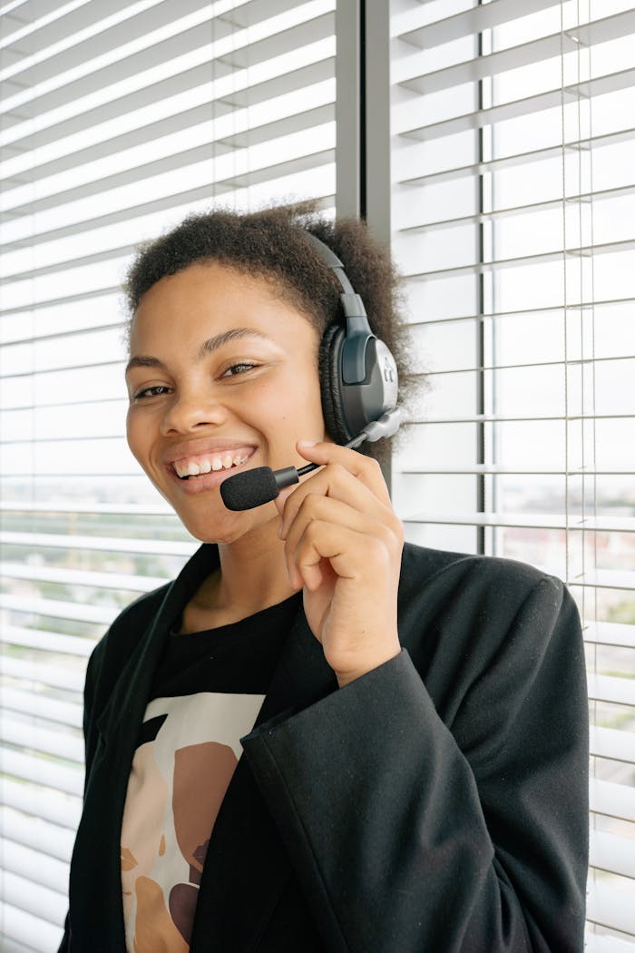 our-story Friendly customer support agent wearing a headset in an office setting, ready to assist clients.