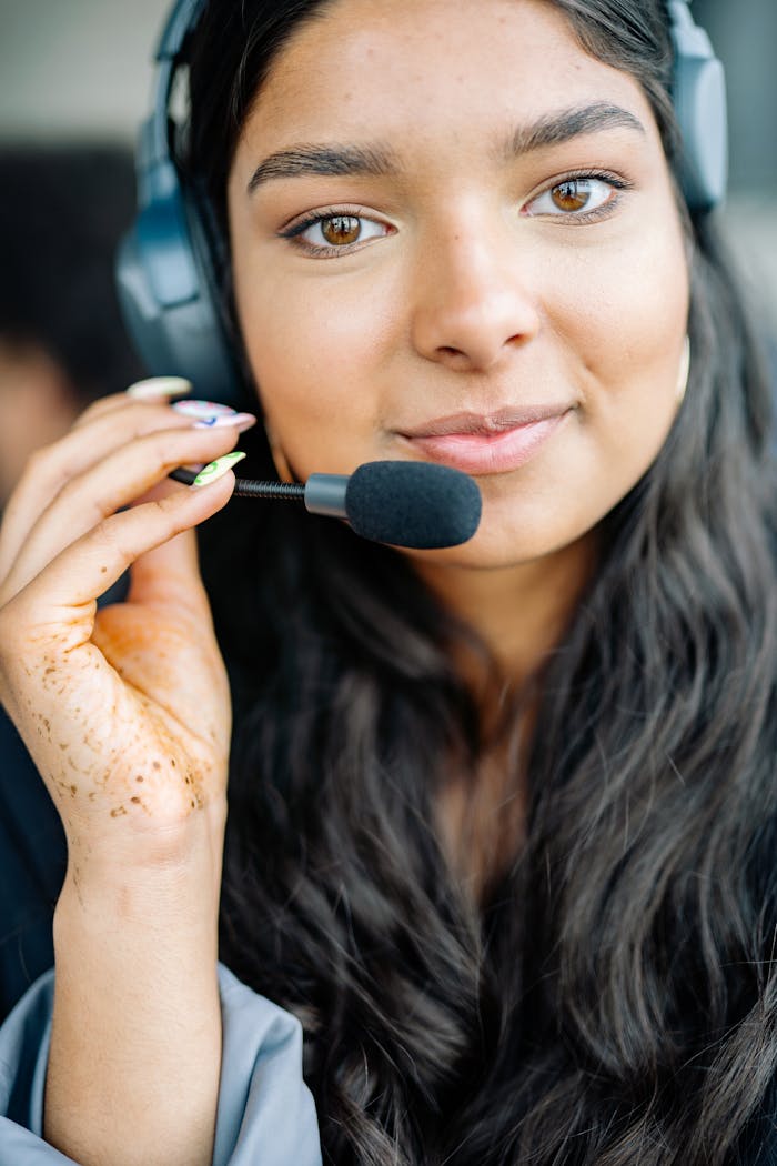 home-img A young woman providing customer support with a headset, smiling confidently.